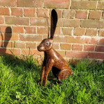 Sitting hare sculpture against wall