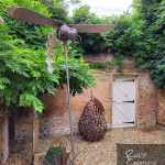 Hornet and pear metal sculptures in walled garden