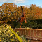 Metal leaping hair sculpture on wall