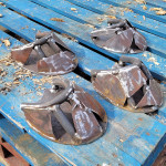 Metal horse hooves in production on blue pallet