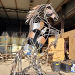 Metal horse sculpture in production outside Rusty Creations workshop