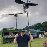 William Moulton-Day holding two hornet sculptures at Hellingham Hall Garden Show