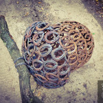 Recycled horseshoe sculpture laying on a country road