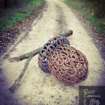 Metal fallen acorn sculpture made from horseshoes