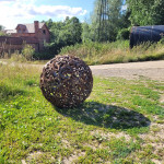 Metal sculpture in summer sun creating shadow