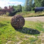 Metal sculpture in summer sun creating shadow