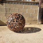 Rusty Creations misfit horseshoe sphere outside the workshop