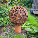 Chimney mounted horseshoe sphere in garden