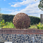 Sculpture on garden wall made from metal horseshoes