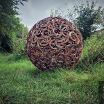 900mm diameter horseshoe sculpture in rough grassland